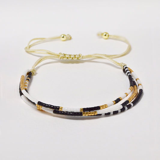Fashion adjustable cotton and neutral tone beaded multi strand bracelet