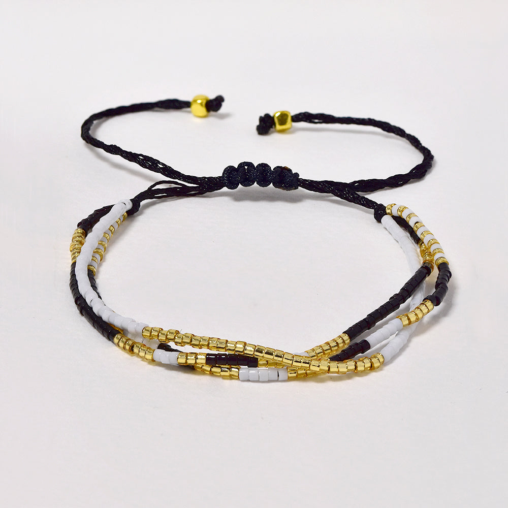 Fashion adjustable cotton and neutral tone beaded multi strand bracelet