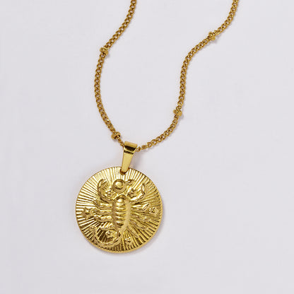 Stainless steel gold plated necklace with zodiac sign on round disc