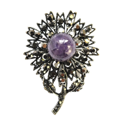 Gunmetal flower brooch with purple pearl centre